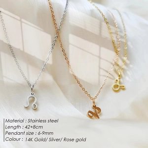Close-up of stainless steel zodiac pendant necklaces in gold, silver, and rose gold.