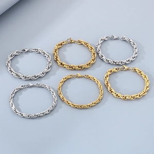 Detailed view of twisted rope chain bracelets in polished gold and silver finishes