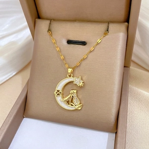 Golden moon and cat necklace with sparkling zircons displayed in a premium jewelry box