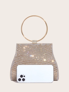 Detailed view of luxury gold evening clutch bag with shimmering rhinestones and round handle