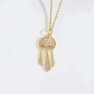 Detailed view of the gold-plated fringe pendant necklace with sparkling zircon accents