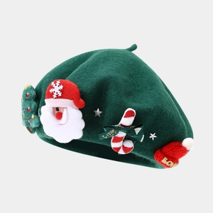 Detailed texture of green wool beret with Santa Claus and Christmas tree decorations