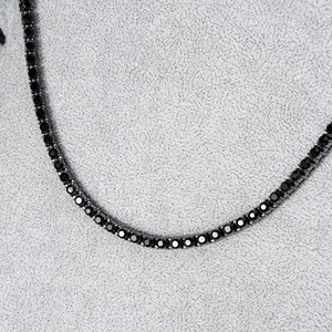 Macro view of 4mm black tennis chain with round-cut stones in prong setting