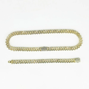 Close-up of gold iced out Cuban link chain set with diamond encrusted fold-over clasps