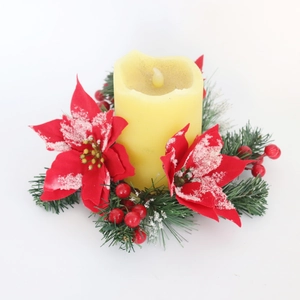 Detail of Christmas candle ring with red poinsettia and snowy cedar pine needles