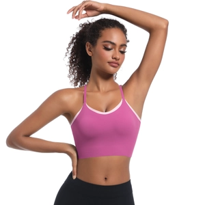 Detail of pink sports bra with cross back straps and light pink contrast trim
