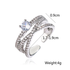 Detail view of silver crossover ring with zirconia stones and size dimensions info