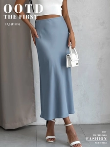 Detail of light blue satin midi skirt showing elegant glossy fabric and drape