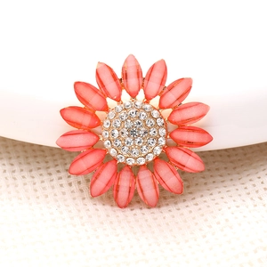 Detailed macro view of coral pink sunflower accessory with sparkling center rhinestones