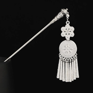 Detail of Miao silver hairpin with floral engraving and long swaying metal tassels