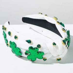 Detail of white knotted headband with green sequin shamrocks and emerald rhinestones