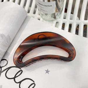 Large tortoiseshell hair claw clip in dark brown acrylic for a minimalist elegant style