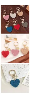 Close-up of sparkling heart-shaped keychains with rhinestones in various vibrant colors
