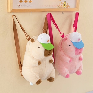 Detail of plush capybara backpacks in beige and pink with soft fuzzy texture
