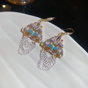 Detailed macro of crystal tassel earrings with sparkling beads and silver-tone chains
