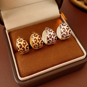 Detail view of vintage leopard print hoop earrings in gold and silver finish
