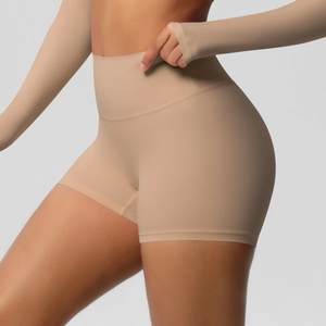 Macro detail of high-waist yoga shorts showing seamless brushed fabric and peach lift