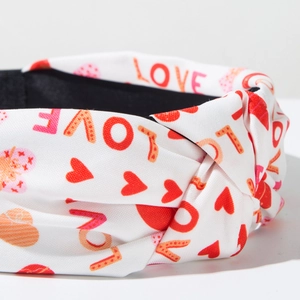Detail of fabric headband featuring red hearts and LOVE print for Valentine's Day