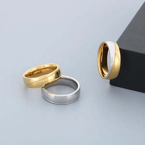 Polished stainless steel spiral textured rings in gold and silver on a jewelry box