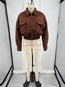 Detail of brown suede jacket showing lapel collar, zip closure, and elastic waist