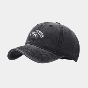 Close-up of white AQUIVER letter embroidery on dark grey washed cotton baseball cap