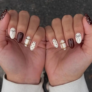 Brown bow and polka dot pattern almond shaped press-on nails with warm tones