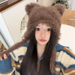 Detail of brown plush earflap hat with cute bear ears and straps on a female model