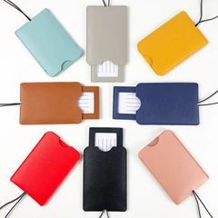 Flat lay of eight multi-color PU leather ID card holders with lanyards and insert cards