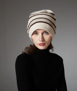 Close-up of beige knitted beanie with brown stripes featuring warm wool texture detail