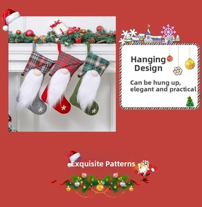 Close-up of three Christmas stockings with gnome motifs, plaid cuffs and white snowflake prints