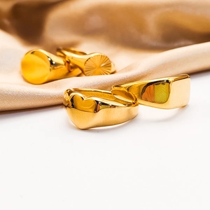 Detail view of a four-piece set of chunky 18K gold-plated heart and signet rings