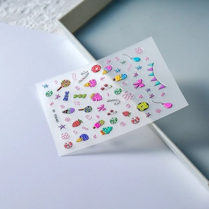Detailed macro view of 5D embossed nail art stickers featuring ice cream and candy patterns