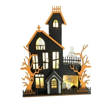 Detailed view of a multi-layer glowing wooden Halloween ghost house decoration with pumpkins