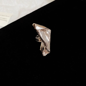 Macro shot of silver irregular folded texture ring on black velvet background