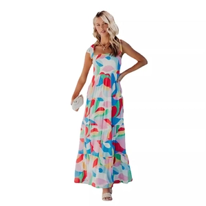 Women's summer boho maxi dress with colorful abstract floral print and tiered skirt design