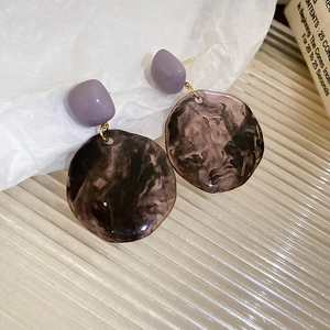 Detail view of purple matte stud and smoky marble resin hoop earrings with gold links