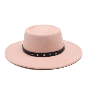 Detail of pink wool fedora with black decorative band and silver star metal rivets