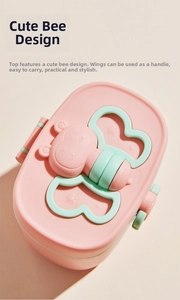 Close-up of pink bee-shaped baby formula container with foldable green wing handles