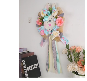 Close-up of Easter bunny wreath with fabric roses, decorative ribbons and silk tassels