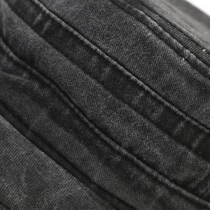 Macro view of dark grey washed cotton fabric with parallel stitching on a vintage military cap