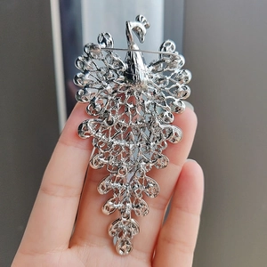 Silver peacock brooch pin with hollow design and crystal rhinestones for women