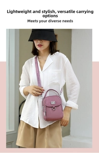 Close-up of lilac nylon crossbody bag showing the front buckle pocket and branded wide strap