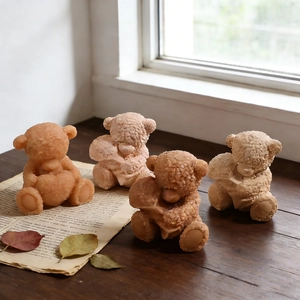 Set of 4 bear candles with knitted texture and heart detail on vintage wood