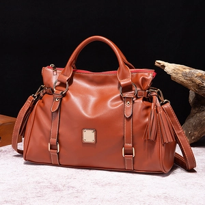 Bolso de mano vintage de cuero marrón con herrajes dorados y borla para mujer