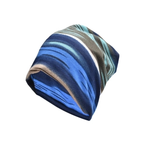 Detail of blue and brown striped tie-dye knit beanie with premium elastic texture