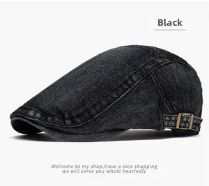 Detail of vintage black denim flat cap showing brass buckle and reinforced stitching