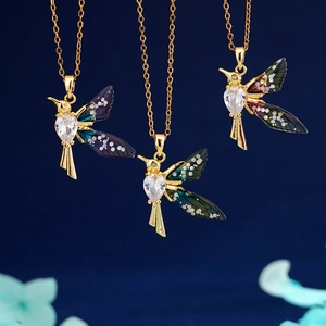 Charming gold hummingbird necklace with heart crystal and iridescent blue wings