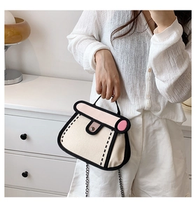 Detailed view of 2D cartoon style canvas handbag with pink flap and silver chain strap