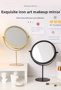 Minimalist desktop makeup mirror with thin metal rod and round base on white desk