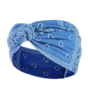 Close-up of blue paisley yoga headband featuring a twist knot design and elastic fabric